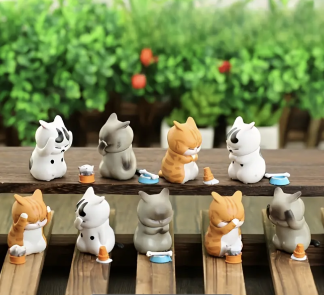 cat figures covering their faces